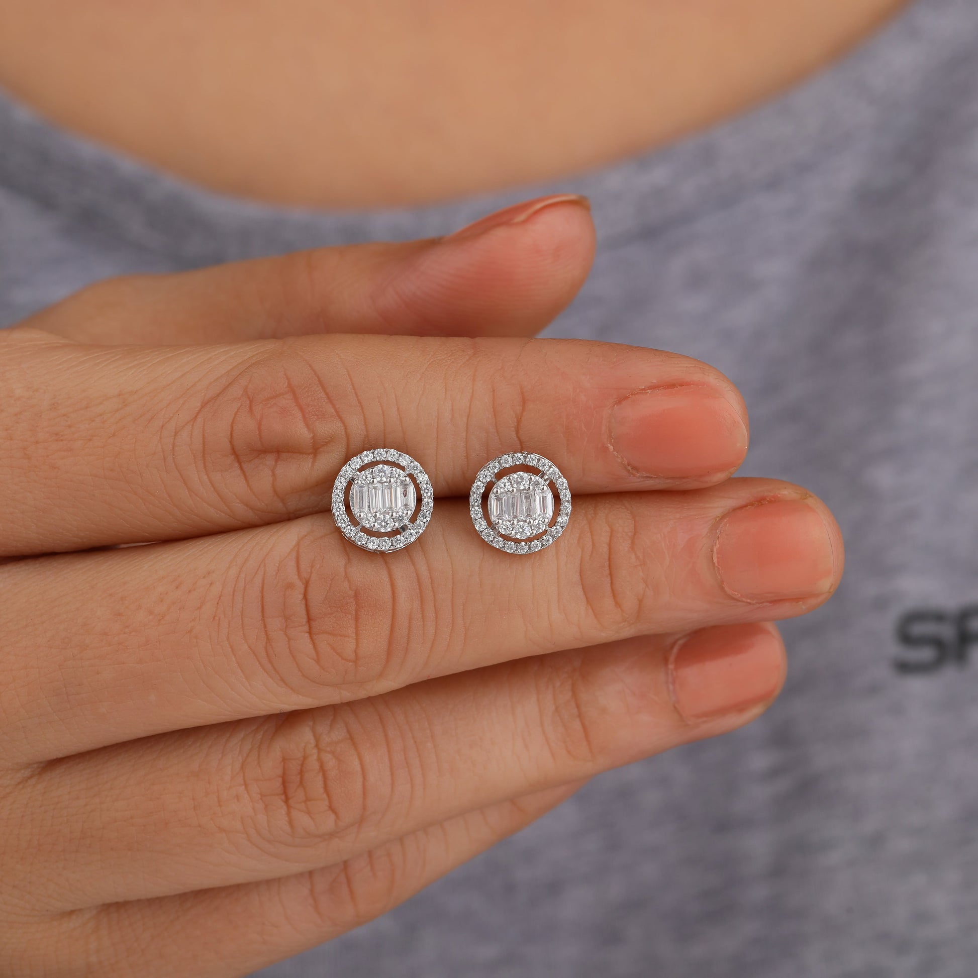 a person holding halo stud earring