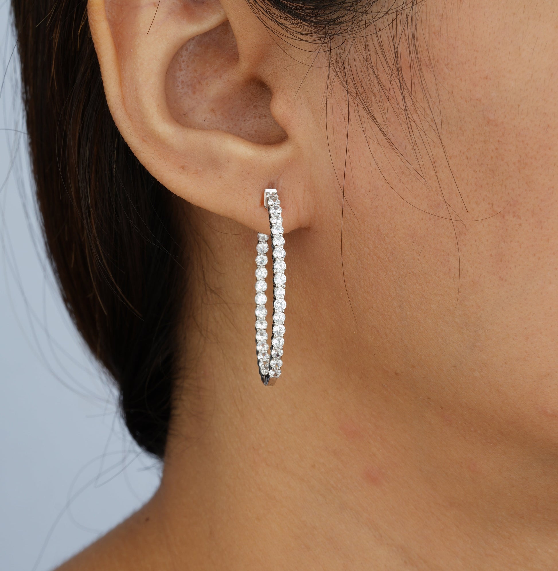 a girl wearing sparkling diamond hoop earring