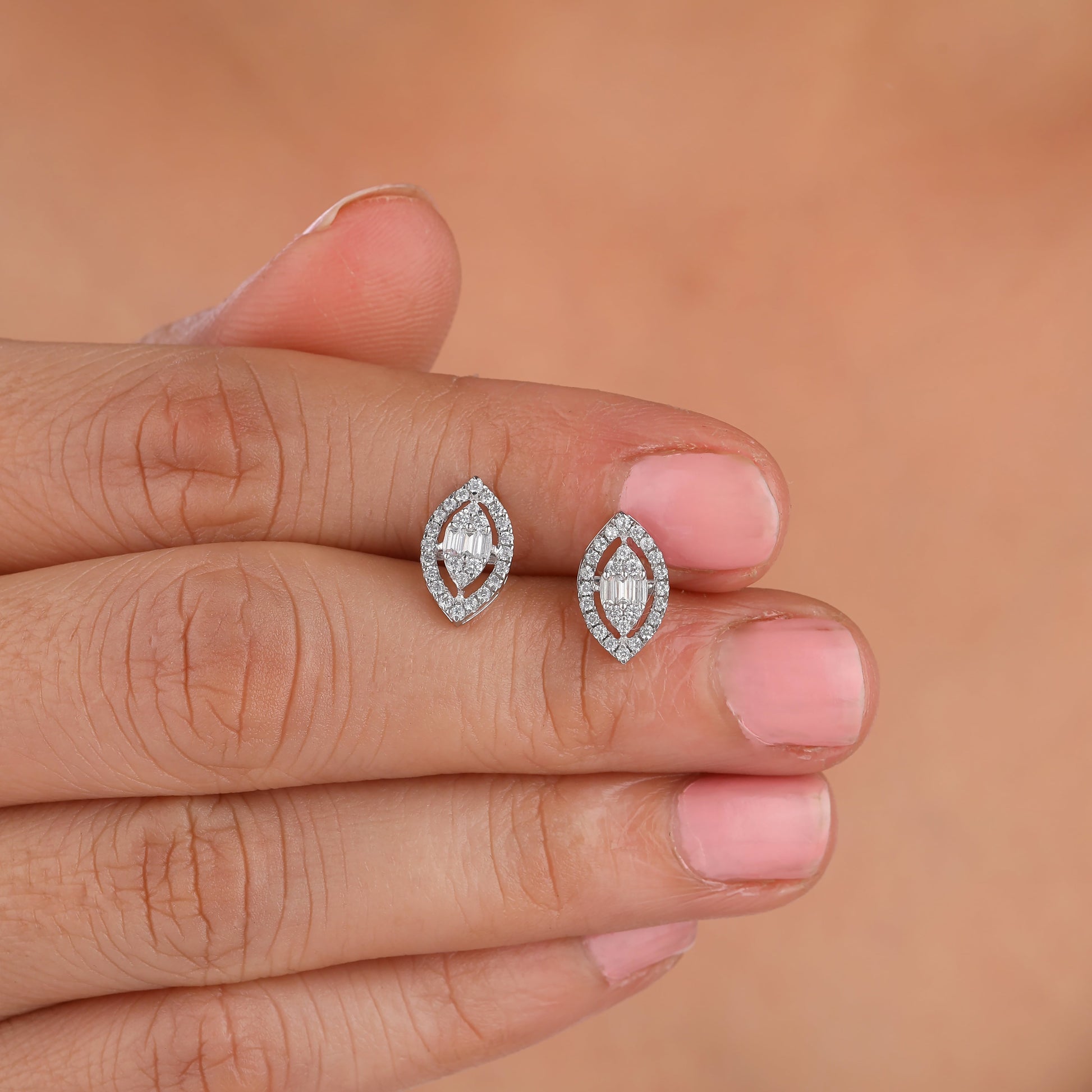 she is holding Marquise illusion Moissanite Stud Halo Earring