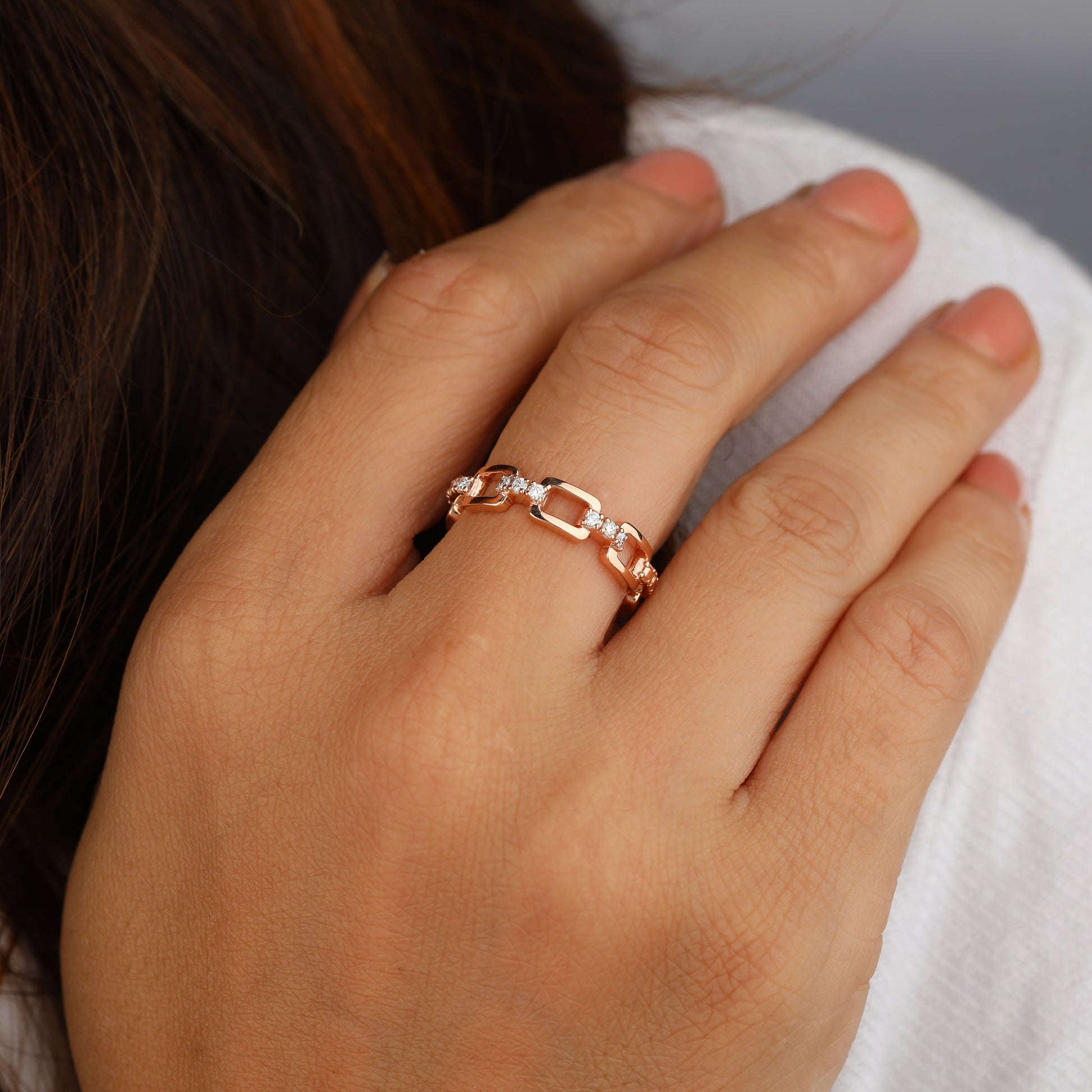 a person has accented chain link ring