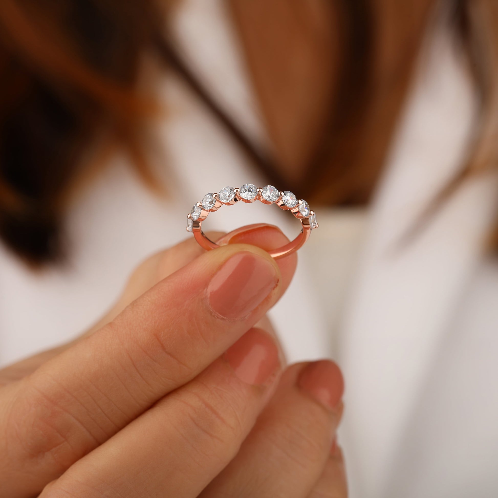 A person holding half wedding band