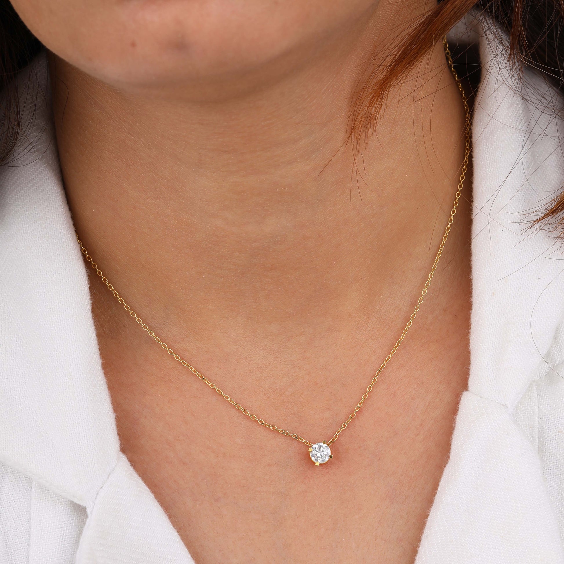 a person has wearing solitaire necklace