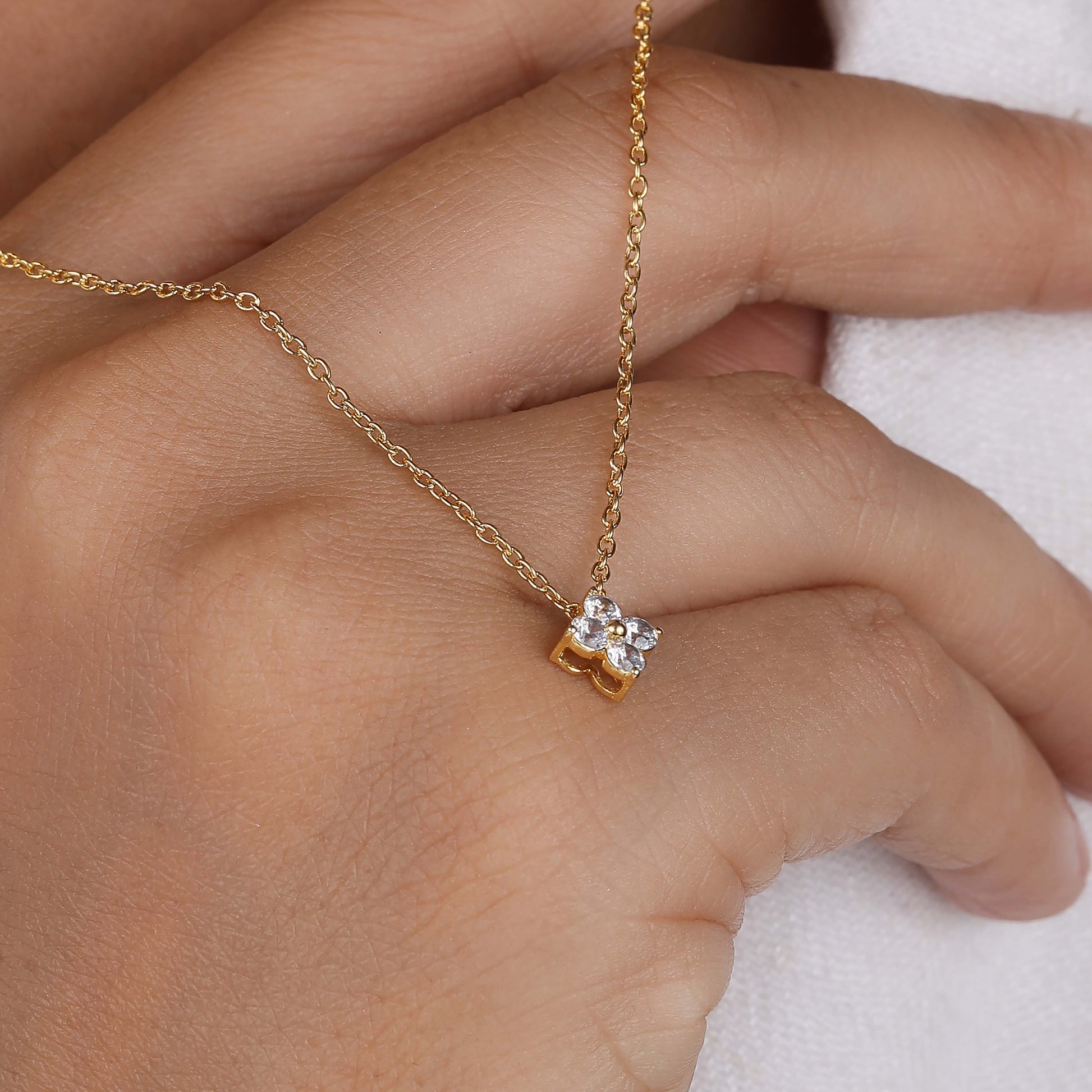 a diamond necklace on women hand