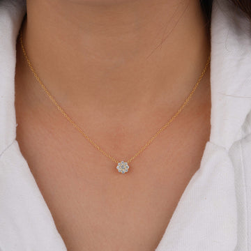 a person wearing a diamond heart necklace 
