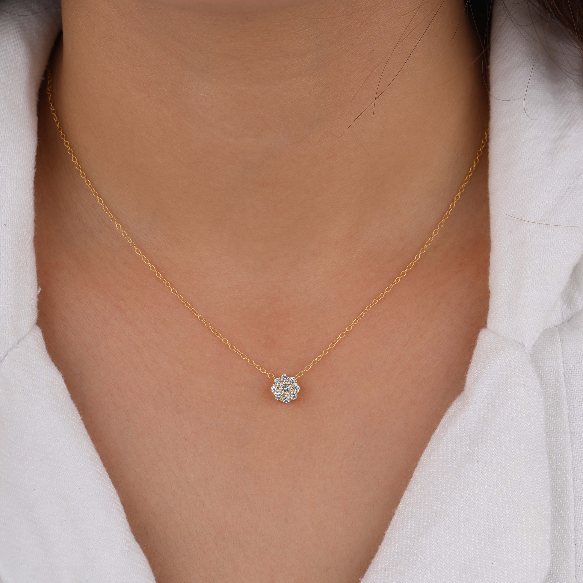a person wearing a diamond heart necklace 