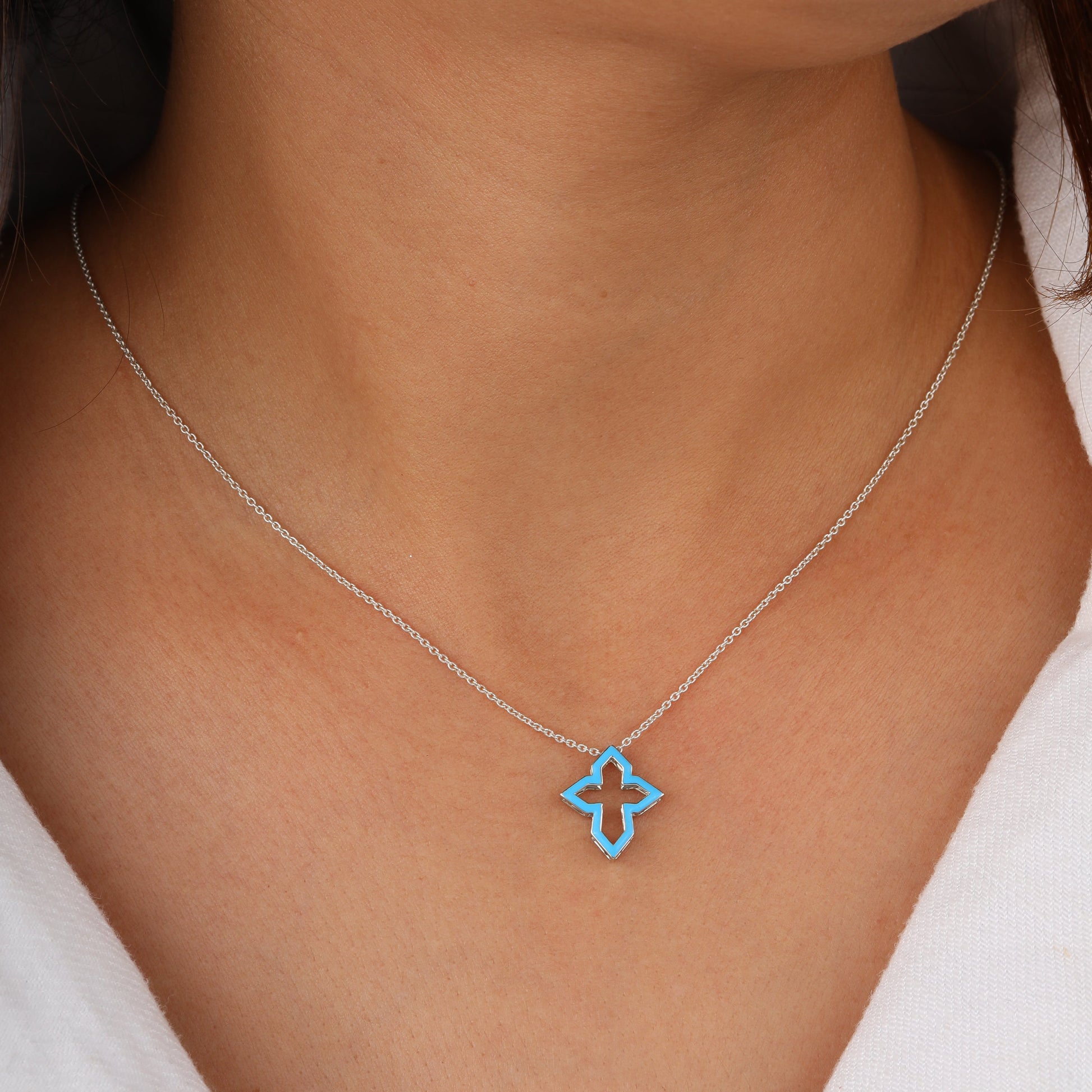 cross necklace with blue jacket