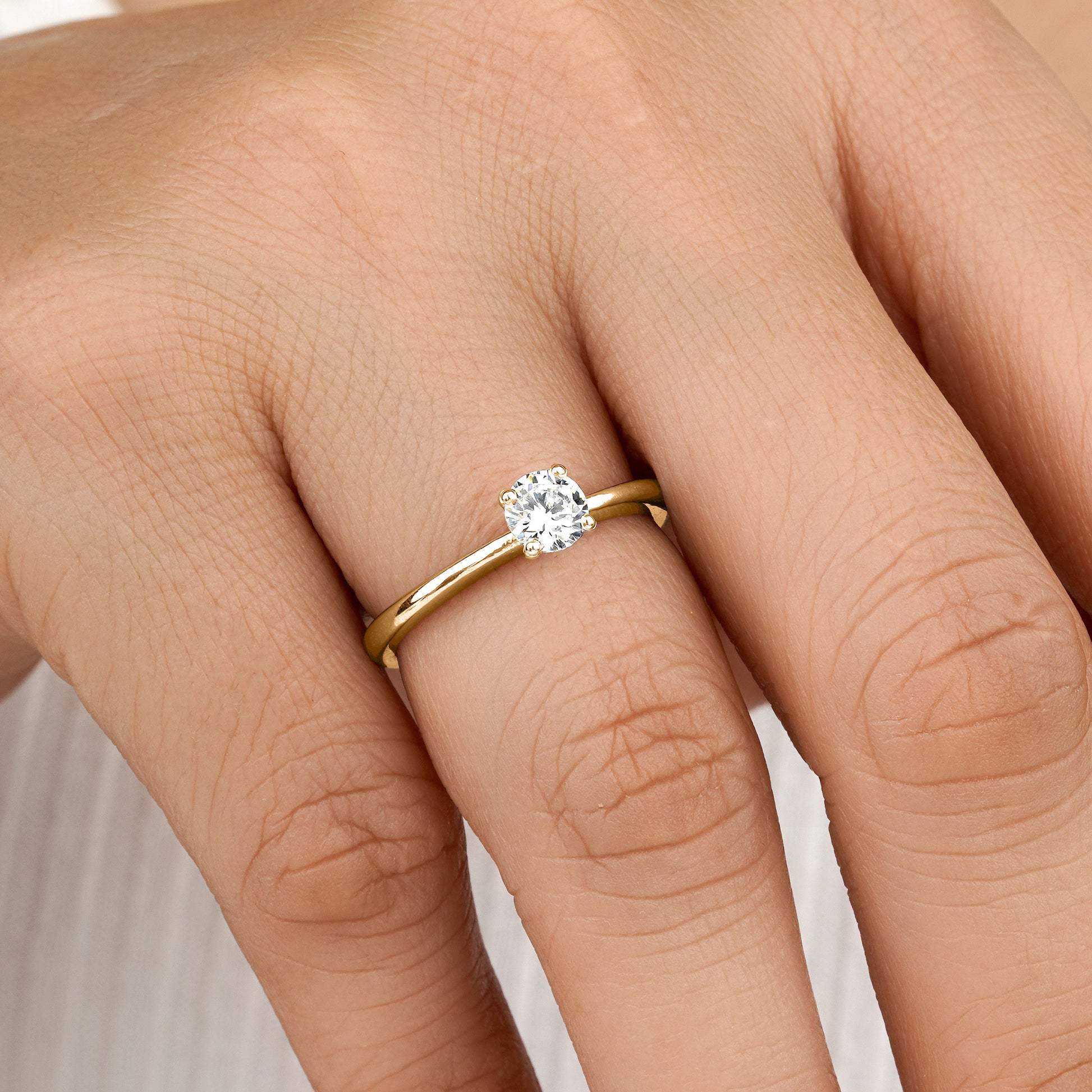 Moissanite engagement ring on model hand