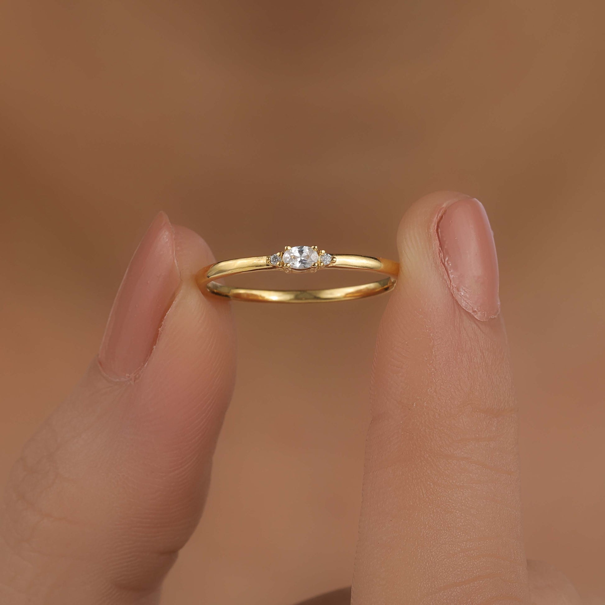 a person holding diamond engagement ring