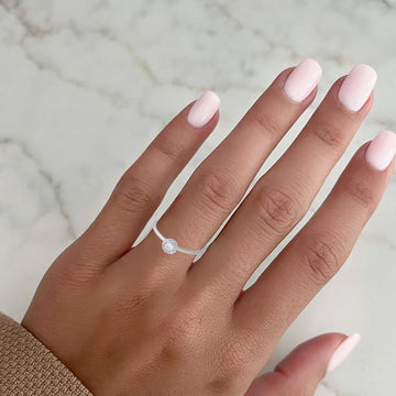 white gold halo ring on her hand
